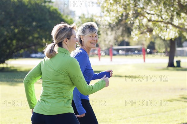 Caucasian women jogging in park
