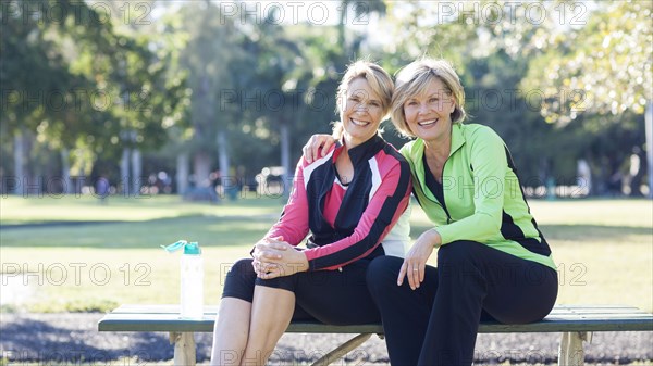 Caucasian women sitting on picnic table in park