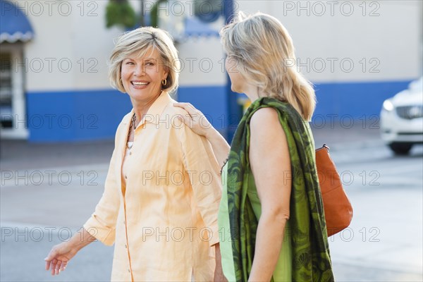 Caucasian women walking in city