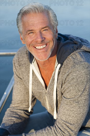 Caucasian man smiling on boat deck