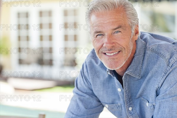 Caucasian man leaning on counter