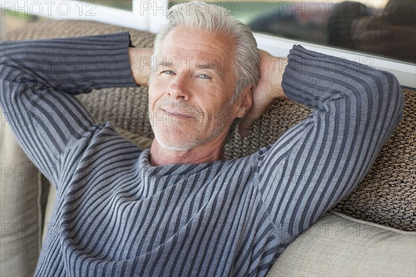 Caucasian man relaxing on sofa