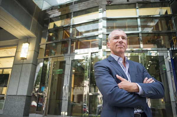 Caucasian businessman standing outside office building