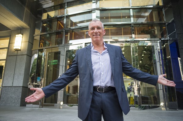 Caucasian businessman standing outside office building