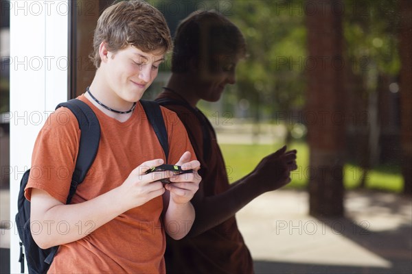 Caucasian teenage boy using cell phone