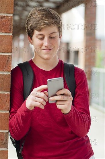 Caucasian teenage boy using cell phone