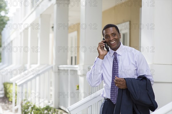 Black businessman talking on cell phone