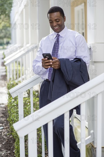 Black businessman using cell phone