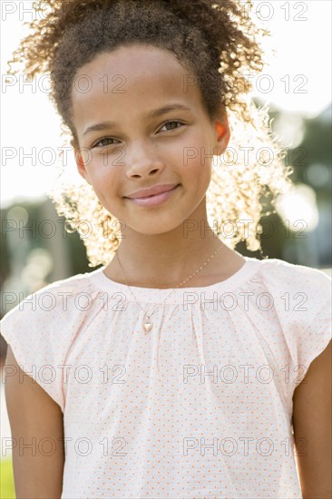 Mixed race girl smiling outdoors