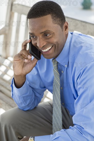 Black businessman talking on cell phone