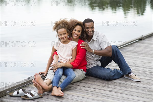 Family smiling on wooden dock