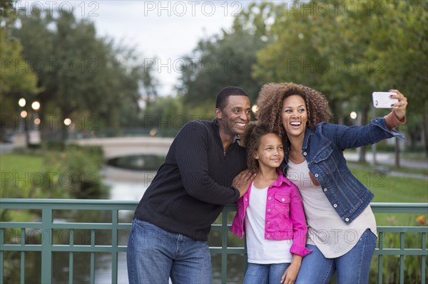 Family taking selfie on bridge