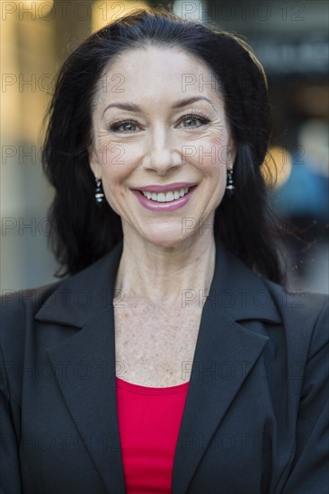 Caucasian businesswoman smiling outdoors