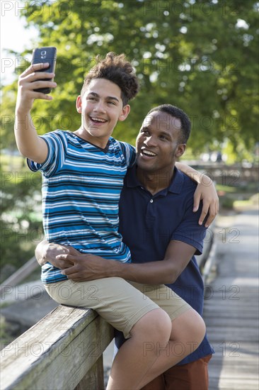 Father and son taking selfie outdoors