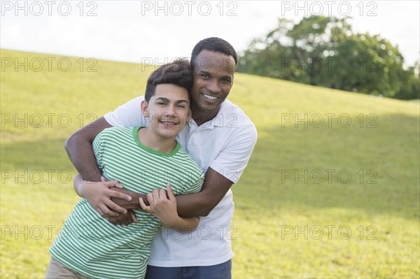 Father and son hugging in park