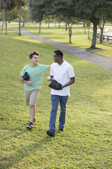 Father and son playing catch in park