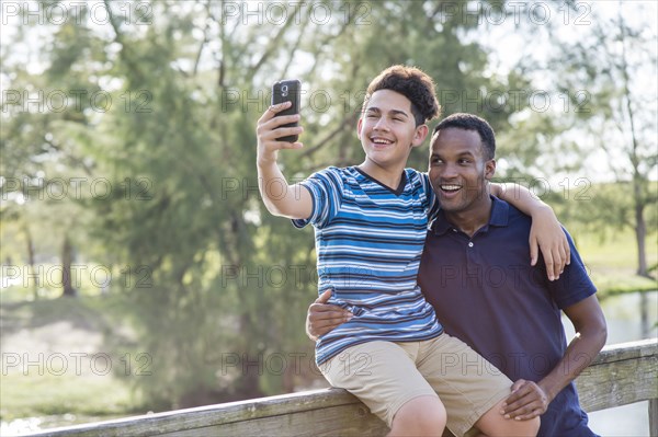 Father and son taking selfie outdoors