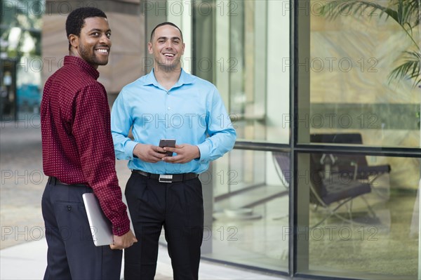 Businessmen smiling outdoors