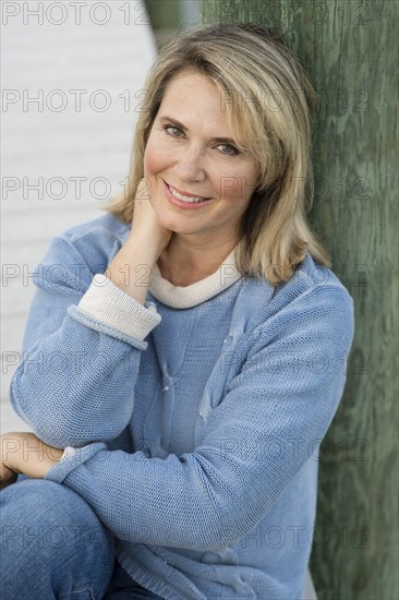 Older Caucasian woman leaning on pier