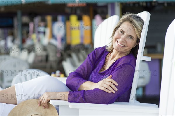 Caucasian woman sitting in lawn chair