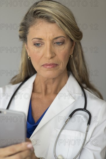 Caucasian doctor using cell phone