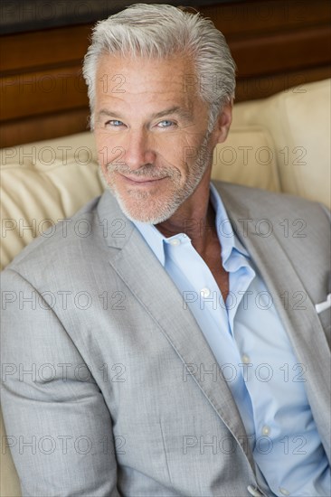 Caucasian man smiling on sofa