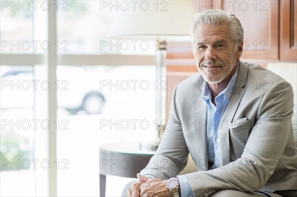 Caucasian man sitting near window