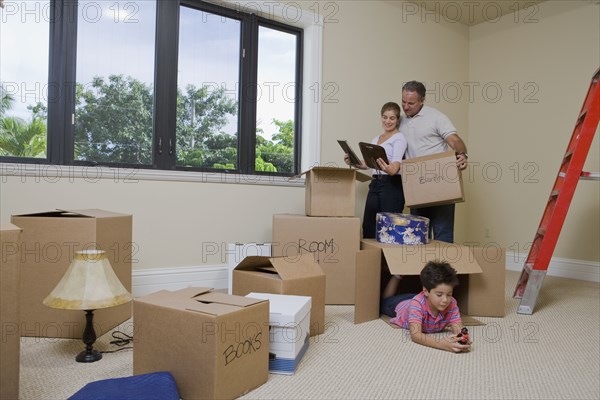 Hispanic family in living room with cardboard boxes