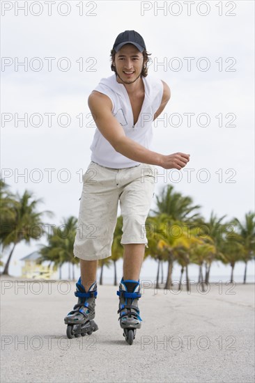 Hispanic man exercising on rollerblades