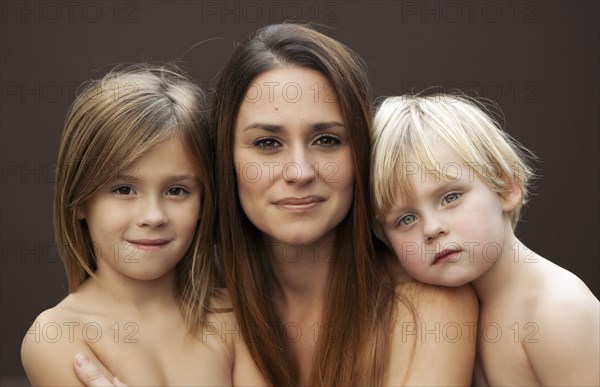 Caucasian mother smiling with sons