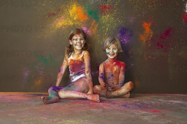 Caucasian children playing with paint