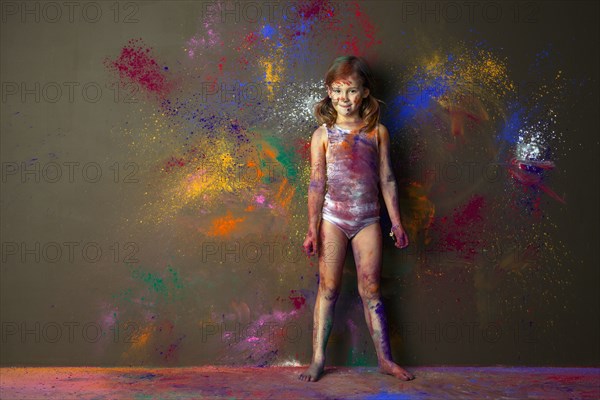 Caucasian girl playing with paint