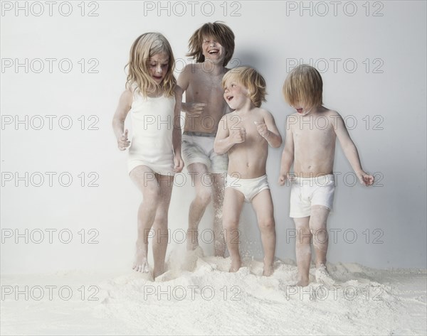 Caucasian children playing in flour