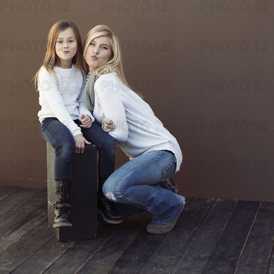 Caucasian mother and daughter smiling together