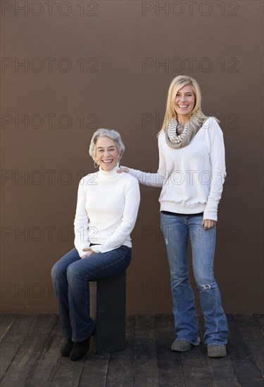 Caucasian mother and daughter smiling together