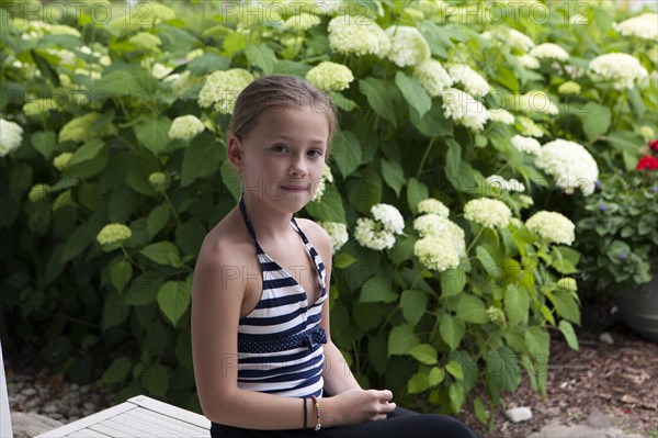 Caucasian girl sitting outdoors