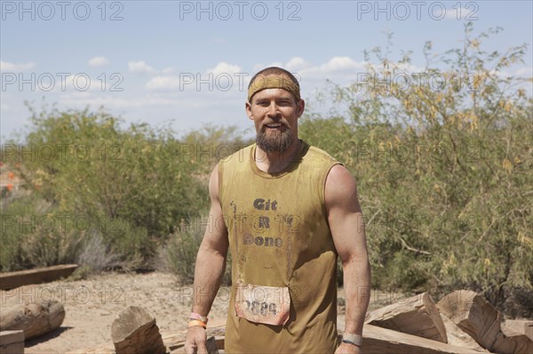 Dirty Caucasian racer in remote landscape