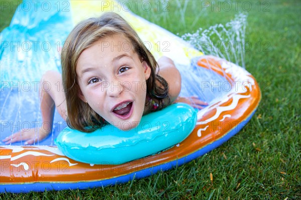 Caucasian girl smiling on water slide