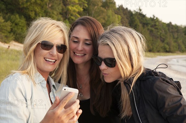 Caucasian women using cell phone outdoors