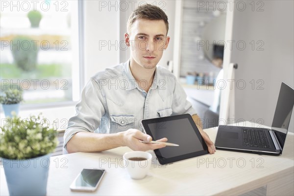 Caucasian man showing digital tablet