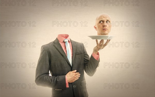 Caucasian man holding his head on platter