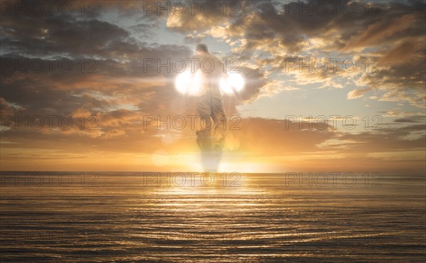Caucasian man flying over ocean horizon