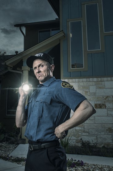 Caucasian security officers posing with flashlight