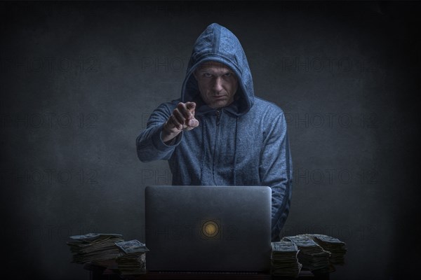 Caucasian hacker stealing money from laptop