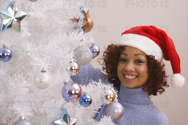 African woman wearing Santa Claus hat