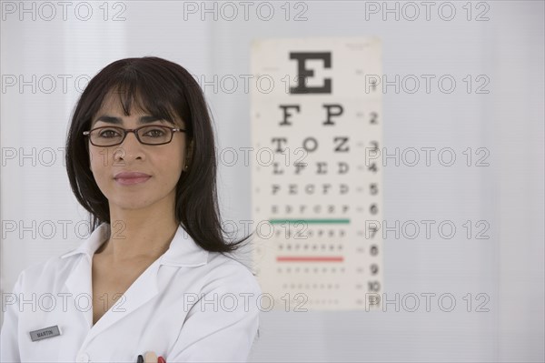 Female doctor in front of eye chart