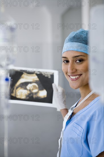 Female doctor holding sonogram