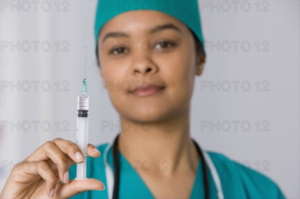 African female doctor holding syringe