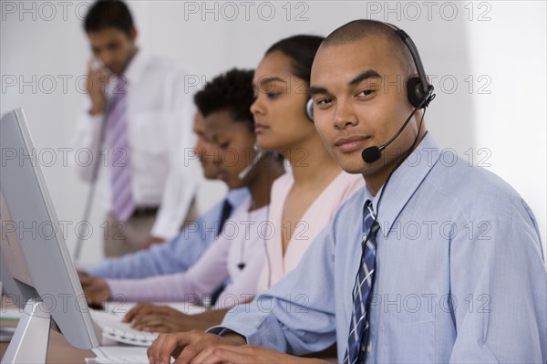Multi-ethnic businesspeople working at computers