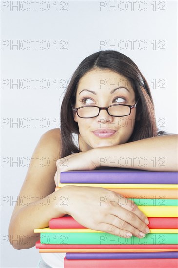 Woman leaning on stack of books